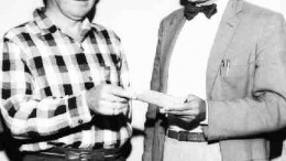 Peter Ribboto, manager of Caland Ore Co., presents the first royalty cheque to M.S. Fotheringham, president of Steep Rock Iron Mines near Atikokan, Ont. Caland Ore leased the "C" property from Steep Rock and began production in 1960.