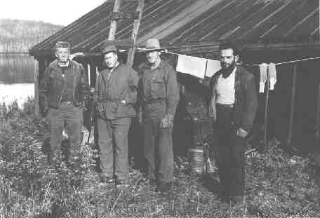 Bush pilot George Smith, left, with Harry Buckles, second from left, a local prospector and the camp cook. The picture was taken during the staking rush of early 1953, near what would become the Nordic mine in the middle belt of the "Z" pattern sedimentary contact.