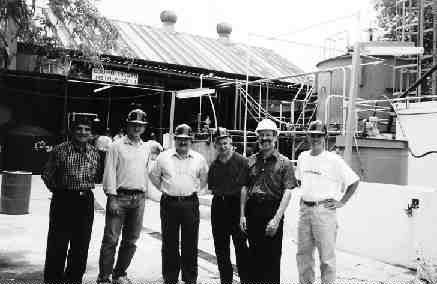 Gathered in front of BacTech's pilot plant are (left to right): Arturo Vaca of Peoles, analyst Ed Flood, Ricardo Benavides Perez of Peoles, BacTech President Geoffrey Donohue, consultant Michael Rhodes, and director Ross Orr.