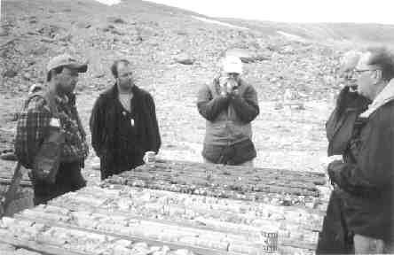 Geological consultants Richard Roy and Antoine Fournier (left to right), analyst Jacques Wortman, Dallas Davis of Twin Mining, and analyst Glen Brown examine core from Cargo I.