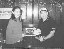 Caitlin Kearns receives several gifts from Dufferin Aggregates resource supervisor Sergio Carbone after touring the company's rock quarry in Milton, Ont.