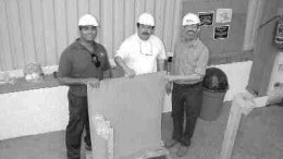 Penoles and BacTech personnel hold a copper cathode produced at the Monterrey demonstration plant.