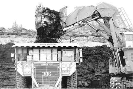 Bitumen is loaded into a mammoth truck at the Muskeg River mine in northern Alberta.