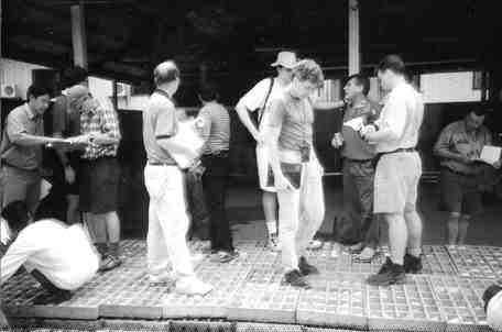 John Felderhof, near pillar at right, shows library core to mining analysts at Busang.