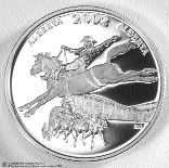 The newly minted coin, pictured here, depicts a saddle bronco and rider with a chuck wagon rig emerging from below. The Calgary Saddledome is in the background.