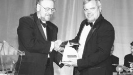PDAC President William Mercer presents the Bill Dennis Prospector of the Year award to Alex Davidson, senior vice-president of exploration with Barrick Gold.