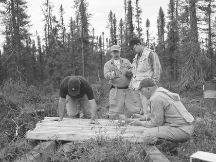 Robert Boyd, Ashton's president and CEO (left), Pierre Bertrand, vice-president of exploration with Soquem, Brooke Clements, Ashton's vice-president, and Robert Lucas, project geologist, examine drill core from a mini-bulk sample from the Renard 3 kimberlite in the Otish Mountains of north-central Quebec.