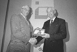 Gatan Lefebvre (left), president of the Order of Engineers of Quebec, presents Ren Dufour with the order's 2003 Excellence Award.