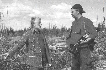 Standing on a diamond-bearing dyke on the 1404 property, Dianor President and CEO John Ryder (left) talks diamonds with James Steel, editor of the online newsletter www.MiningInsights.com.