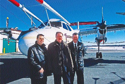 From left, Noranda's exploration manager in the Bathurst camp, Normand Dupras, New Brunswick Minister of Natural Resources Keith Ashfield, and Slam Exploration President Michael Taylor in front of a Fugro Dash-7. The aircraft is to conduct Megatem surveys over the Bathurst camp (see map, right). Noranda and Slam are involved in joint effort to outline base metal reserves for the Brunswick smelter, which is slated to close in 2008 unless more reserves are found. The provincial government is subsidizing the program.