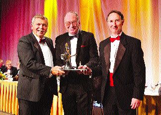 Awards Committee Chairman Edward Thompson presents the Special Achievement Award to John Postle and William Roscoe of Roscoe Postle and Associates.