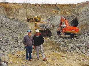 Canadian Arrow Mines Vice President of Exploration Paul Davis (left) and President David Larche stand in front of the bulk sampling operations at the Alexo Nickel property northeast of Timmins, Ont.