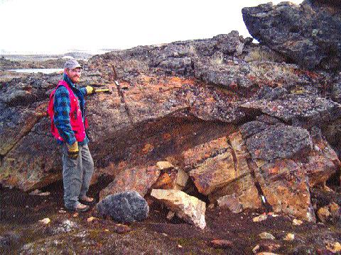 Commander Resources' Project Geologist Lamont Leatherman at an outcrop of the gold-bearing Bravo iron formation at the Ridge Lake prospect on Baffin Island.