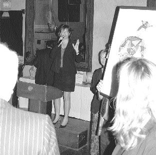 Auctioneer Beth Colle takes bids on a selection from the Toller Cranston Gallery in Toronto. The painting fetched $850.