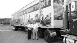 Michael Mayhew (left), Atlas Copco's marketing manager, and Peter Walsh, vice-president of construction, stand outside the company's mobile exhibition.