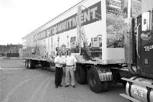 Michael Mayhew (left), Atlas Copco's marketing manager, and Peter Walsh, vice-president of construction, stand outside the company's mobile exhibition.