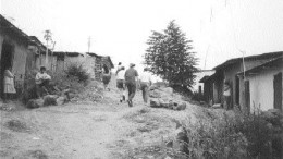 Mining personnel from Manhattan Minerals walk through the village of Tambogrande in northwestern Peru in 1999. Local opposition to Manhattan and its Tambo Grande project eventually scuttled the company's plans to develop rich polymetallic deposits under and near the town.
