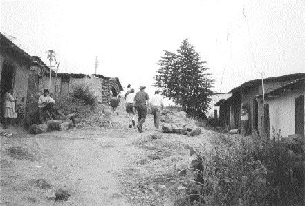 Mining personnel from Manhattan Minerals walk through the village of Tambogrande in northwestern Peru in 1999. Local opposition to Manhattan and its Tambo Grande project eventually scuttled the company's plans to develop rich polymetallic deposits under and near the town.