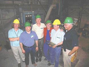 Photo by James WhyteCentury Mining staff display a newly poured dor bar from Sigma, from left: Exploration Geologist Erika Shepherd, Chief Operating Officer Michael Werner, Vice-President Graham Eacott, President Margaret Kent, General Manager Jean-Luc Chouinard, and Vice-President Adrian McNutt.