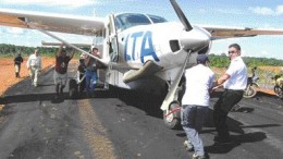 Grounded: Crystallex executives didn't know it at the time but this photo of company executives pushing a plane stuck on a runway in Venezuela -- taken by The Northern Miner during a recent site visit -- would serve as a metaphor for the company's troubles in the Latin American nation. The Crystallex saga in Venezuela took a strange turn recently when President Hugo Chavez made statements in support of nationalizing the country's mineral assets.