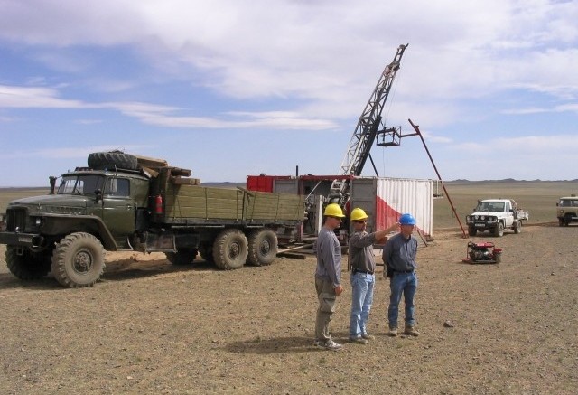 (from left) QGX's Jim Cambon - corporate development, VP of project exploration Michael Sharry and chief geologist Patrick Redmond in front of a Major Drilling Longyear 44 rig at the Baruun Naran coal project in southern Mongolia.