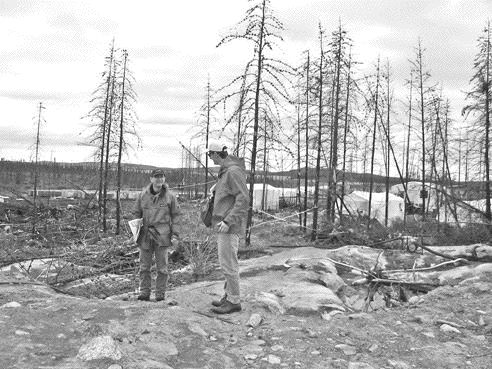 Andr Gaumond, president and CEO of Virginia Gold Mines, shows a gold analyst around the lonore gold property in Quebec's James Bay region during the summer of 2005.