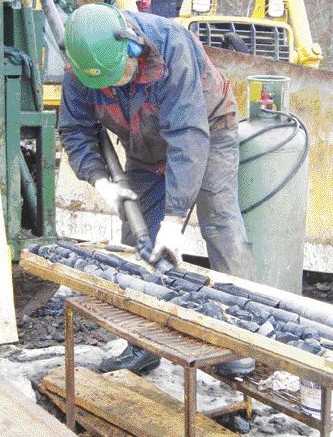 ACADIAN GOLD<A driller handles core on the Main zone at Acadian Gold's Beaver Dam gold project in Nova Scotia.