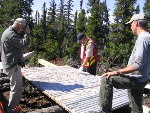 (from the left) Mining analyst Glenn Brown, Aurora Energy chief scientist Rick Valenta and vice-president of exploration Ian Cunningham-Dunlop examine drill core at the Jacques Lake project in coastal Labrador's Central Mineral Belt.