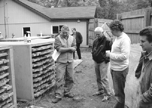 JAMES WHYTEBob Mann (left) and David Black (middle, foreground) of Aquila Resources display core from the Back Forty massive sulphide project in Michigan.