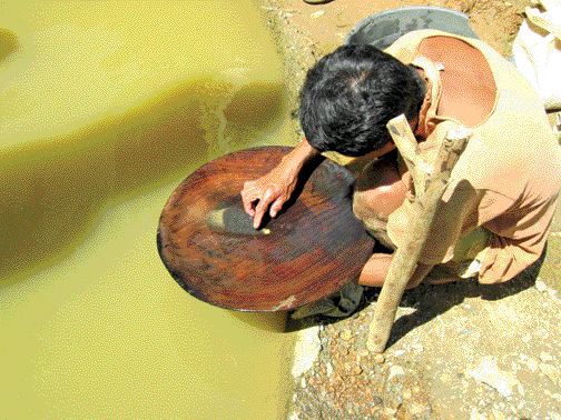 MINDORO RESOURCESOne of many local gold panners on Mindoro Resources' Agata project area in northern Mindanao, Philippines. The company believes that allowing the locals to continue gold panning is good for community relations.