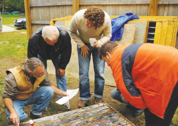 BY JAMES WHYTEBob Mann (kneeling) of Aquila Resources shows core taken from the Back Forty massive sulphide project on Michigan's Upper Peninsula.