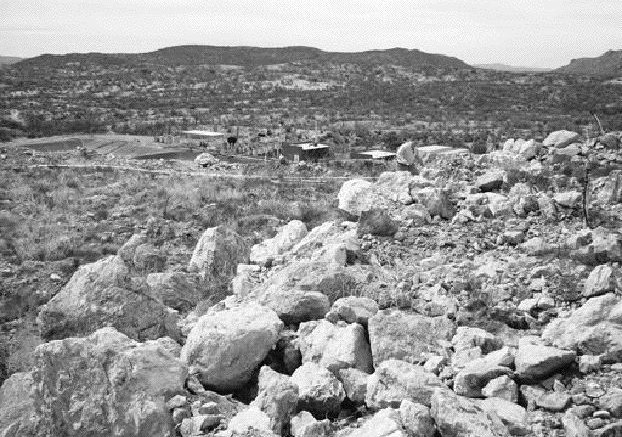 COLUMBIA METALSThe leach pad at the Lluvia de Oro mine in Sonora state, Mexico, with the leach plant in the background. Large run-of-mine boulders were placed on the pad by previous operators without crushing.