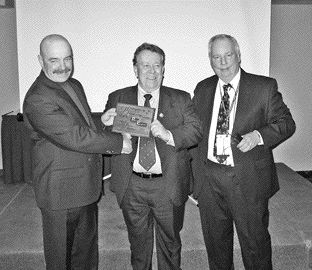 RUBICON MINERALSOPA president Wally Rainer, centre, and Michael Gravelle (right), Minister of Northern Development and Mines Ontario present the award to Perry English, Left