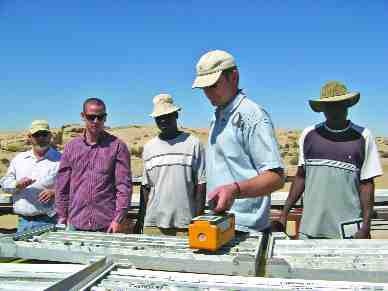 BY SUSAN KIRWINKeith Webb, senior geologist for Extract Resources, uses a spectrometer to show the U3O8 levels in drill core from the Ida Dome area of the company's Husab uranium project in Namibia.