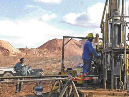 BY ANTHONY VACCAROA worker mans a drill rig while a guard looks on at the Moto gold project in the Democratic Republic of the Congo.