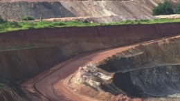 (Top) Miners collect their rescue packs, safety equipment and lamps from the Lamproom prior to going underground at AngloGold Ashanti's Mponeng mine in South Africa. (Bottom) Open-pit mining at the Yatela project in Mali.