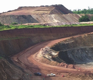 (Top) Miners collect their rescue packs, safety equipment and lamps from the Lamproom prior to going underground at AngloGold Ashanti's Mponeng mine in South Africa. (Bottom) Open-pit mining at the Yatela project in Mali.