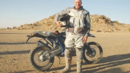 Lukas Lundin, chairman of Lundin Mining, posing in front of his BMW motorbike which he rode from Cairo to Cape Town in 2006 to promote global awareness of critical issues in Africa. Lundin Group has pledged US$100 million to the Clinton-Giustra Sustainable Development Initiative, a program aimed at fighting poverty in developing countries.