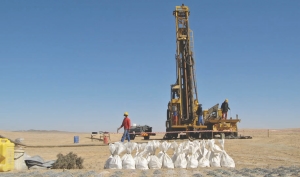 Samples are collected in front of a drill at Bannerman Resources' Goanikontes project in Namibia. The company has announced plans to begin trading on the country's nascent stock exchange this month.