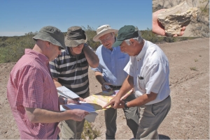 Scouting for uranium at Blue Sky Uranium's Santa Barbara project in Argentina. From left to right: David Terry, Ron McMillan, Clifton Farrell and Jorge Berrizzo. Inset: A piece of petrified wood found at Santa Barbara.