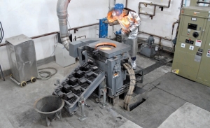 A worker oversees gold pouring at Jinshan Gold Mines' Chang Shan Hao (217) gold project, in China.