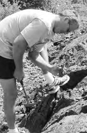 Atlantic Gold geologist Robert Murphy inspecting mineralized outcrop at the company's Cochrane Hill gold project, in Nova Scotia.