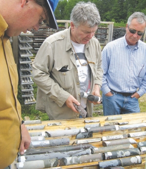 Gordon McRoberts (centre), Augen Gold's project geologist, examines drill-core from the Jerome Mine gold-molybdenum property in northern Ontario.