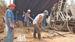 Workers put together core trays by a drilling rig at Pacific Rim's El Dorado gold and silver property in El Salvador. Long delays in getting the permits needed to develop the project have prompted the company to take the government to international court.