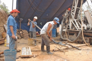 Workers put together core trays by a drilling rig at Pacific Rim's El Dorado gold and silver property in El Salvador. Long delays in getting the permits needed to develop the project have prompted the company to take the government to international court.
