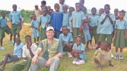 Eurasian Minerals president and CEO David Cole, surrounded by children at the company's Treuil camp, in northwestern Haiti.