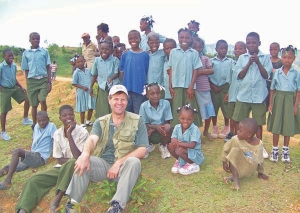 Eurasian Minerals president and CEO David Cole, surrounded by children at the company's Treuil camp, in northwestern Haiti.