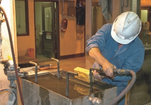 A worker processes a gold dor bar at Yukon-Nevada Gold's Jerritt Canyon project site in Nevada.