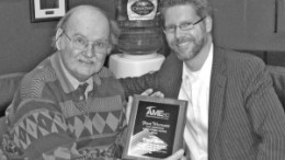 Author Chuck Davis (left) receiving the Frank Woodside Past Presidents Distinguished Service Award from Gavin Dirom (right), president and CEO of the Association for Mineral Exploration British Columbia.