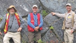 In front of a large outcrop of high-grade coarse-grained specular hematite at Champion Minerals' Fire Lake North iron project in northeastern Quebec, from left: Jean Lafleur, director and technical adviser; Bruce Mitton, senior project geologist; and Jeff Hussey, vice-president of exploration.